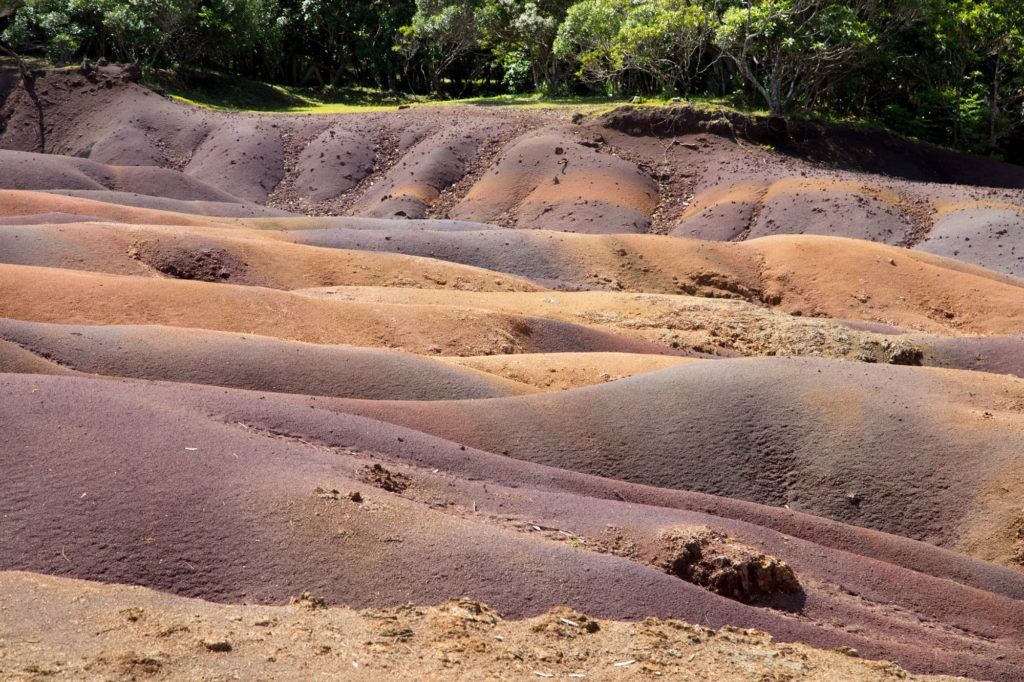 The multi-colored sands of Chamarel brightly exhibit their levels of color.