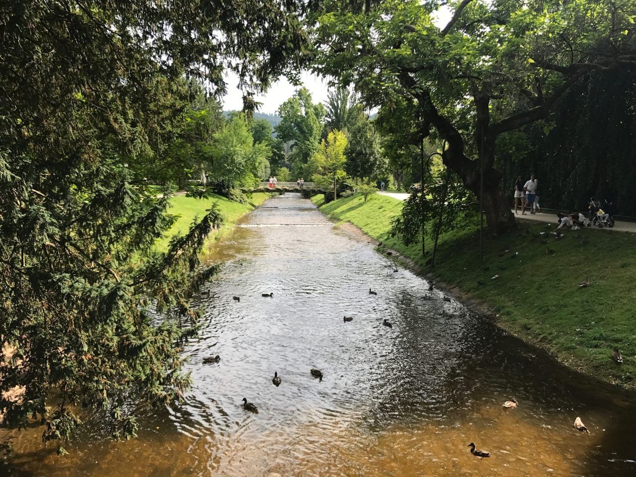 Riverbed and people enjoying a walk during spring in Baden Baden, Germany.
