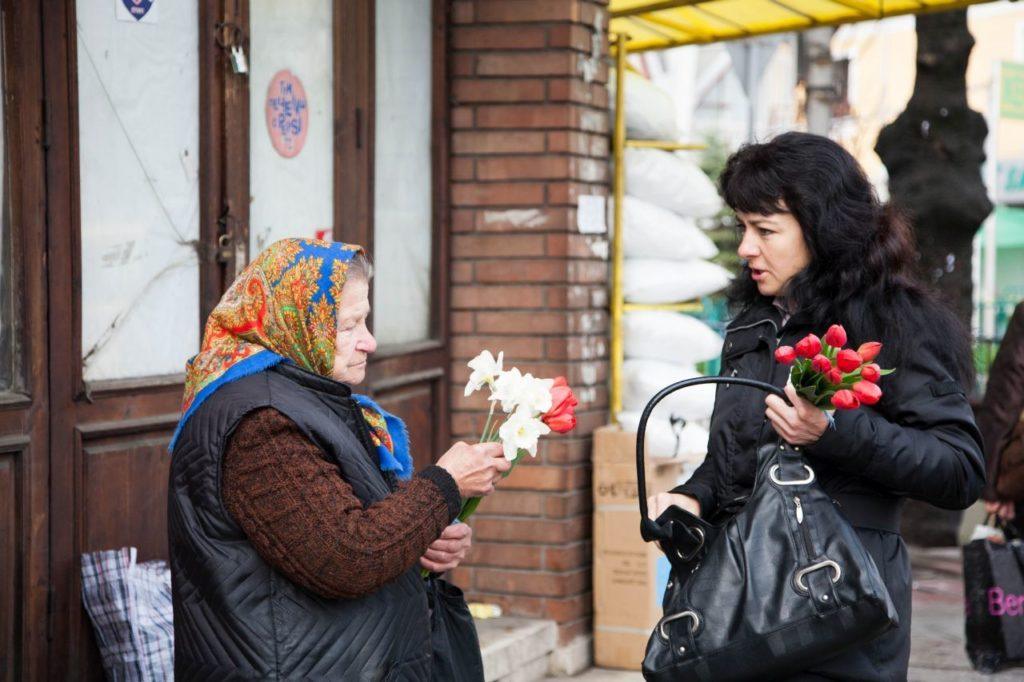 Two women chatting with flowers in Bulgaria. 