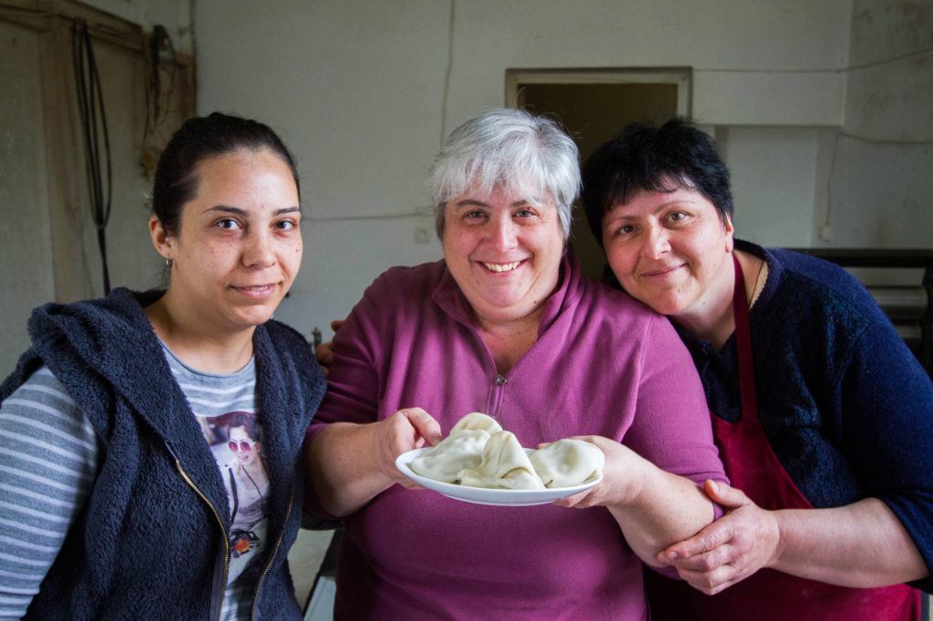 Corinne hold up her plate of khinkali she made in a Georgia cooking lesson.