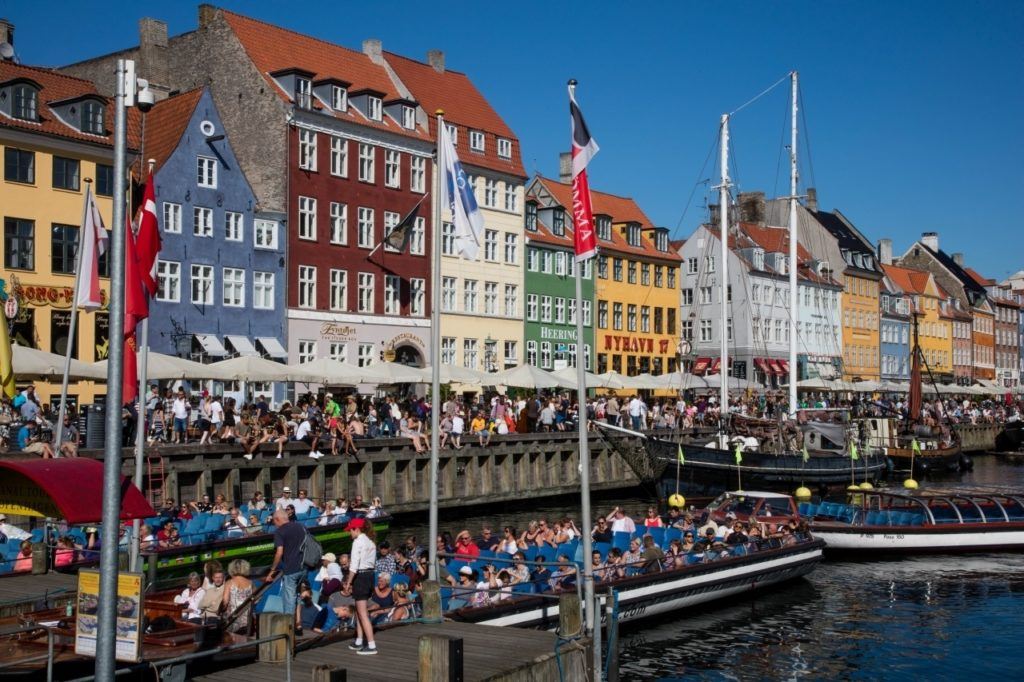 Nyhavn port in Copenhagen bustling with tourists.