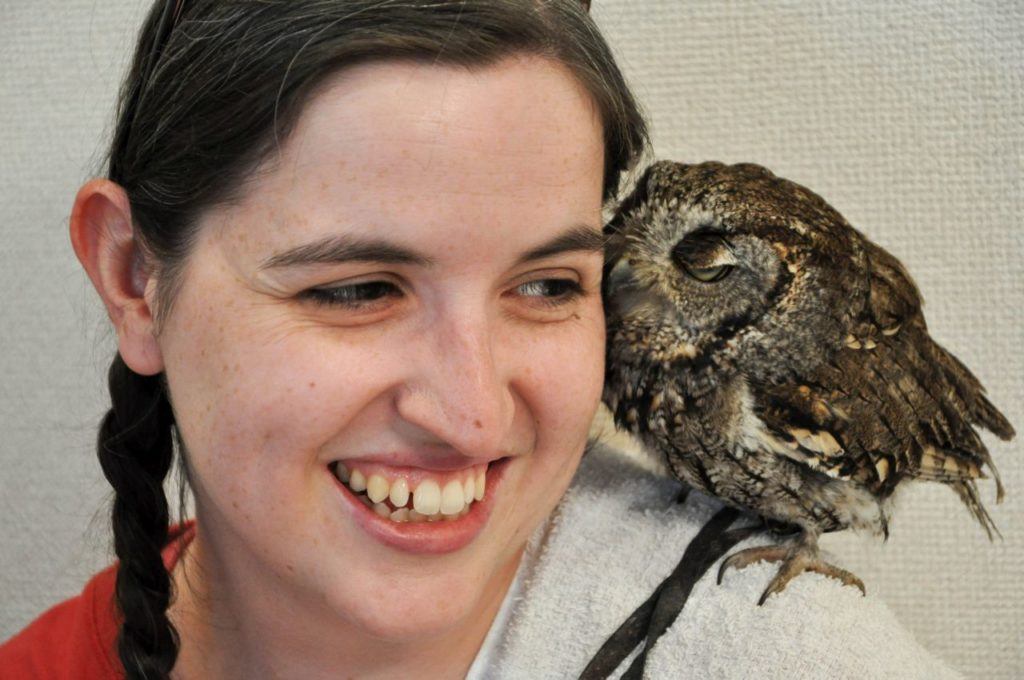 Devon snuggling a pygmy owl.