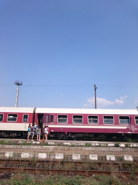 People standing on a Bulgarian train platform waiting on the next train.