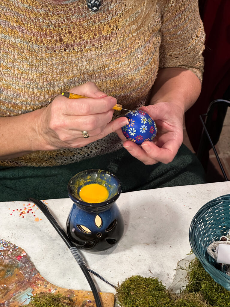 Meticulous designs are painted on an eggshell.