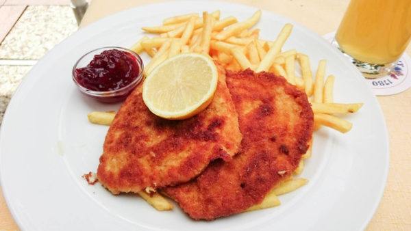 Typical schnitzel with fries and preiselbeeren sauce.