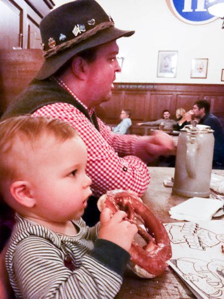 Little boy eating a pretzel.