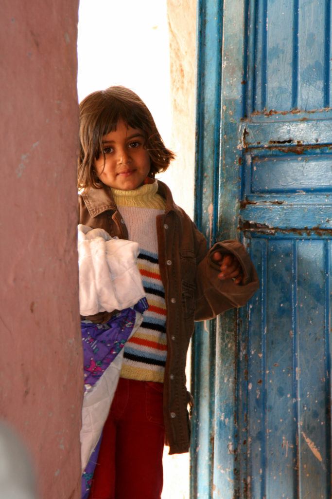 Little girl coming into her house.