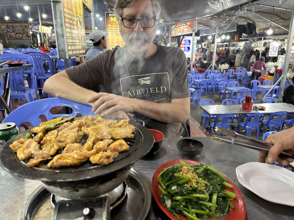 Dalat Night Market dinner, grilled pork and the ubiquitour morning glory.