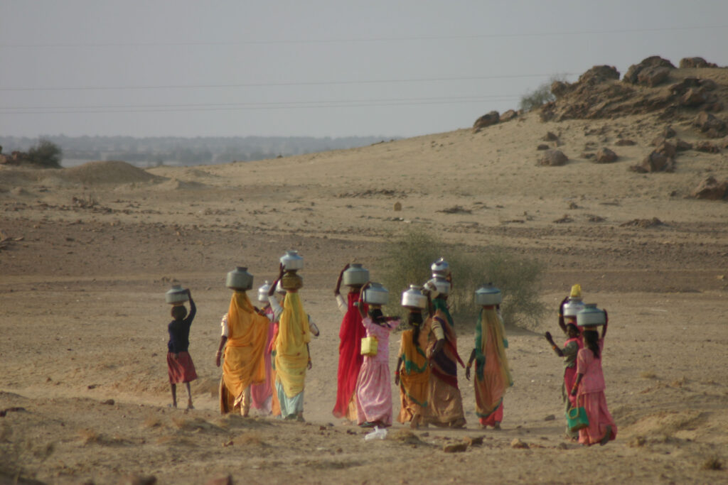 Girls go to the public well to get water.
