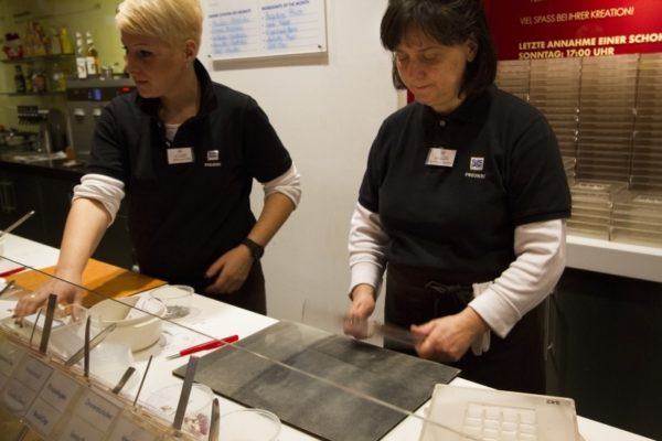 A woman molding the chocolate. 