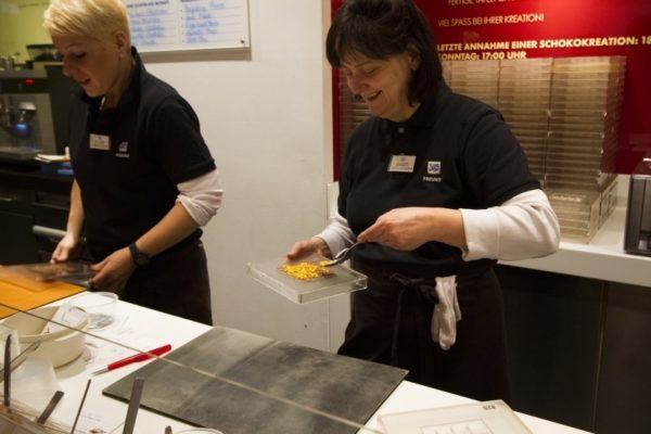 Putting special ingredients on top of your chocolate.