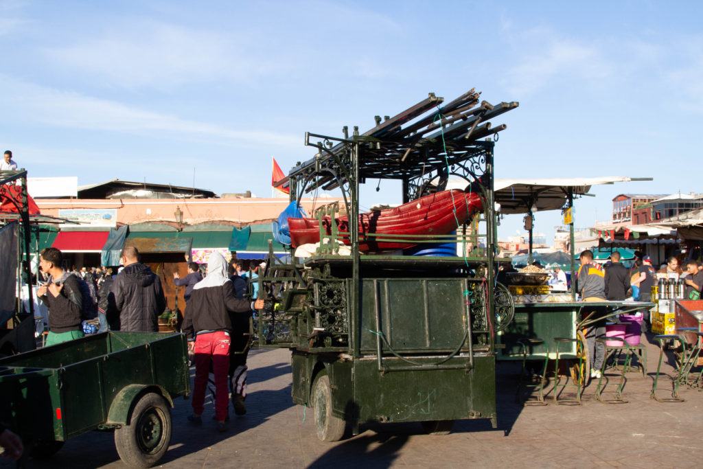 Two-wheeled carts, piled high with equipment, are actually pop-up restaurants with seating, tables and cooking equipment.