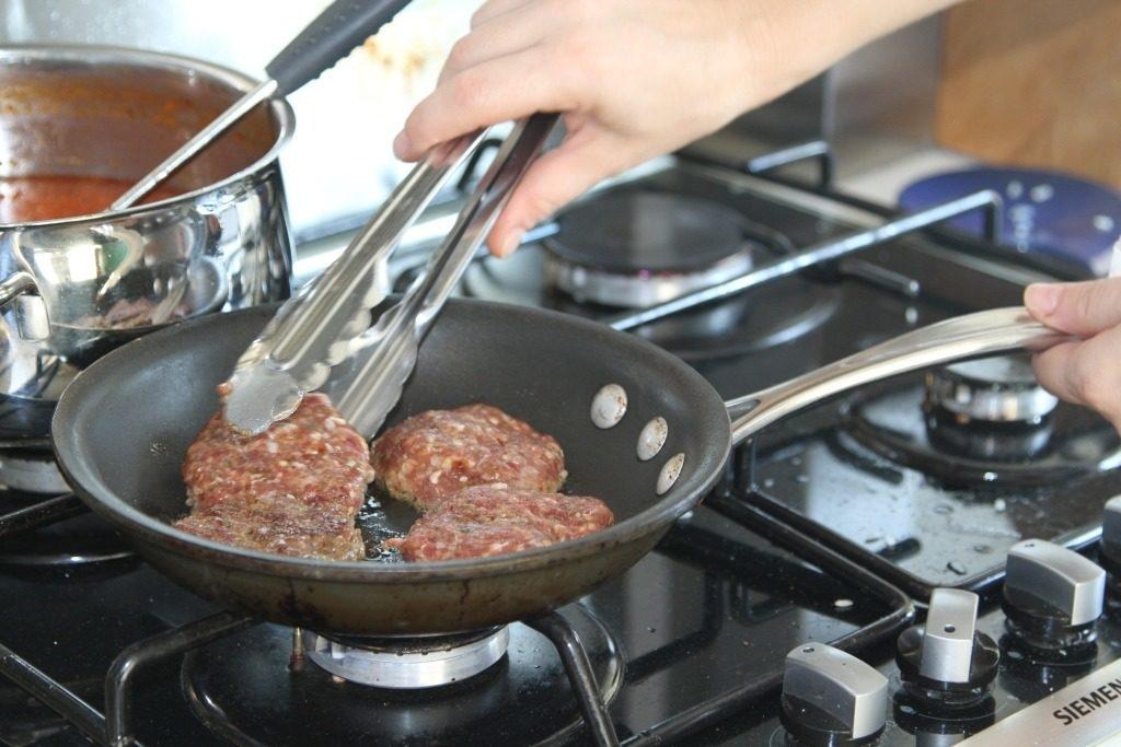 Turkish Food Recipe - Köfte sizzling in the pan.