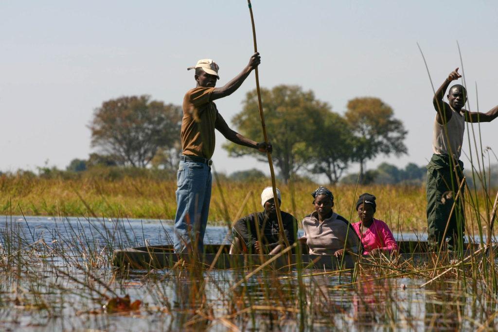 A group of locals poling in the Okavango Delta, a UNESCO World Heritage Site.