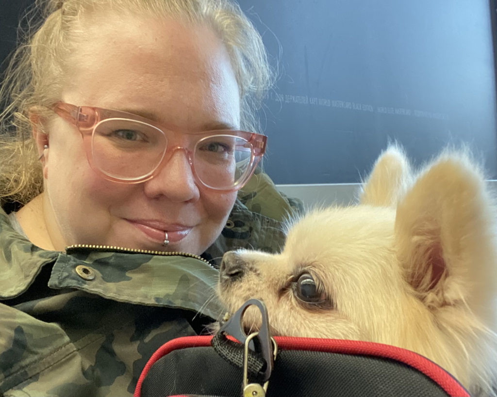 Jenn and one of the ten rescued dogs on a layover in Moscow.
