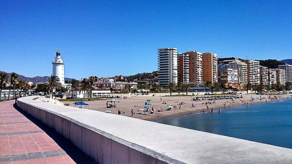 Malaga's beach with a few people on it.