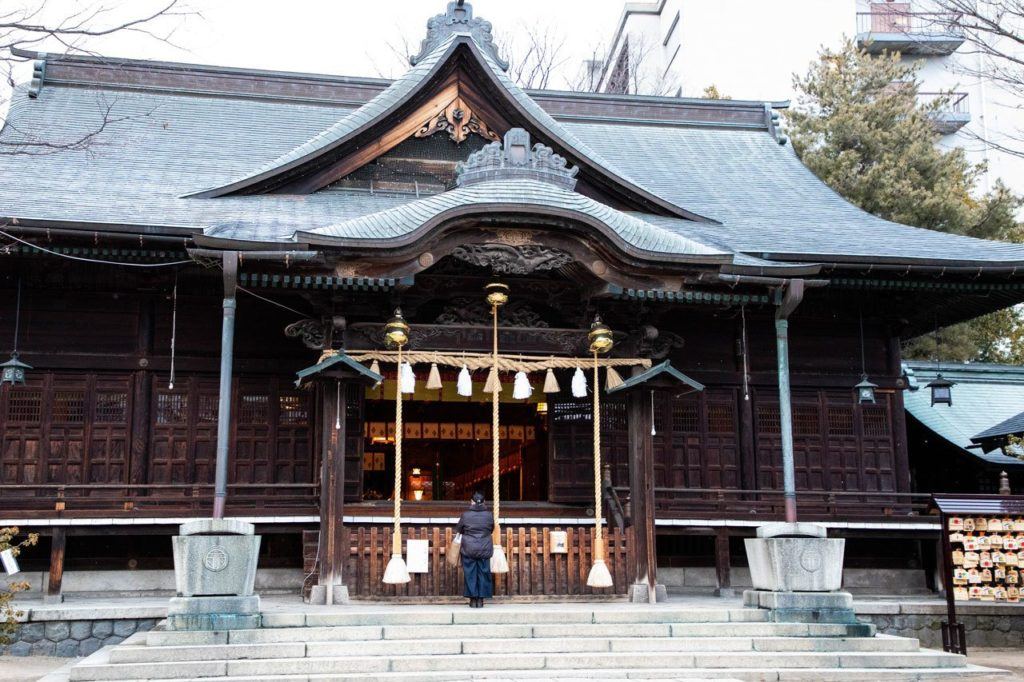 Woman praying at Yohashira Shrine.