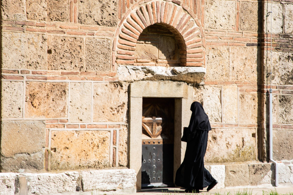 Monk entering the Grancancia Church for Sunday services.