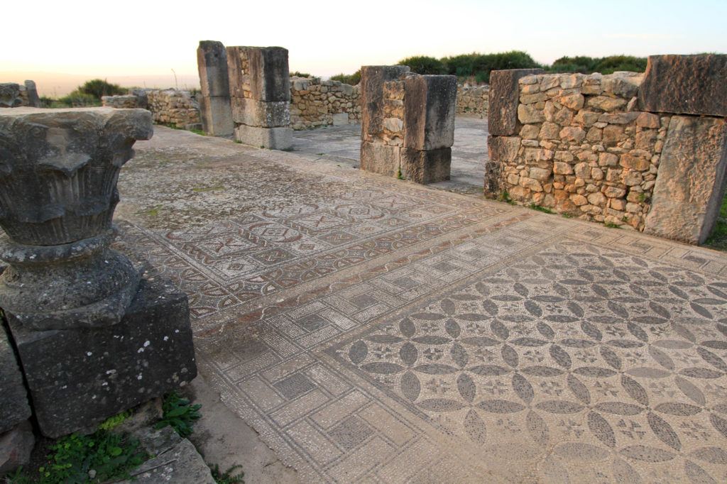A mosaic floor in Volubilis with intricate geometric designs.