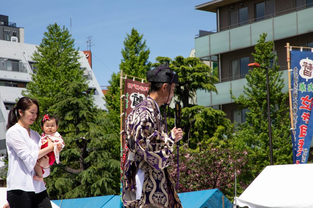 Mother with baby in sumo ring before the contest begins.