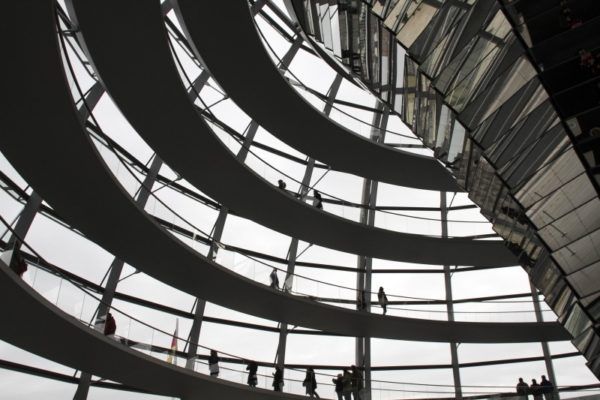 People standing and walking along circular paths around the dome. 
