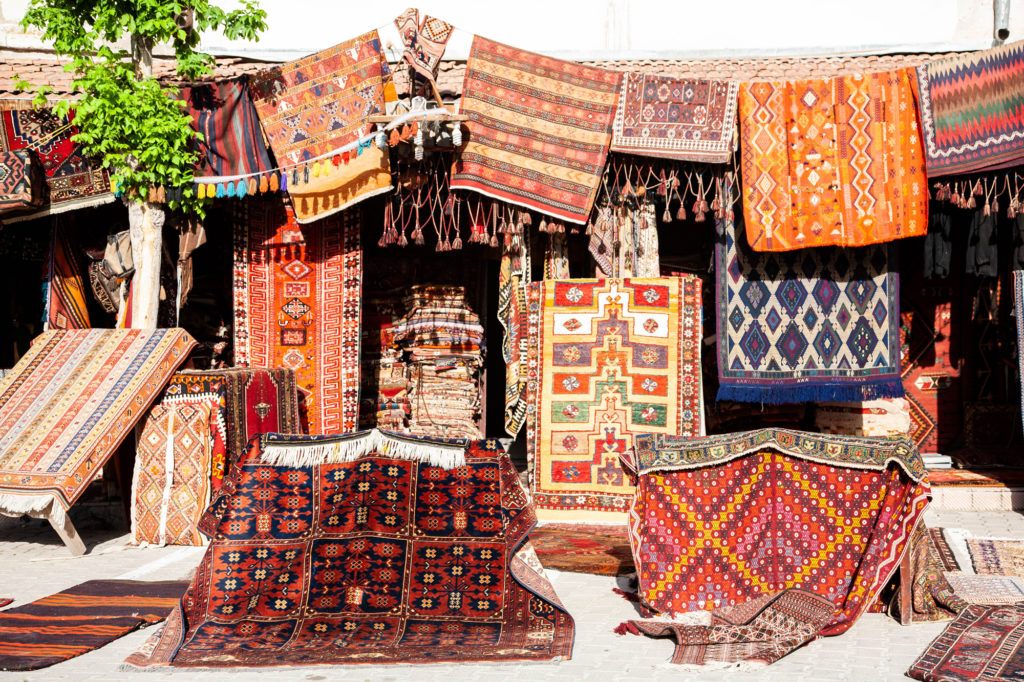 Rug Vendor with rugs and kilims outside of the shop.