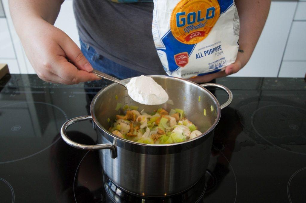 Adding flour to thicken.