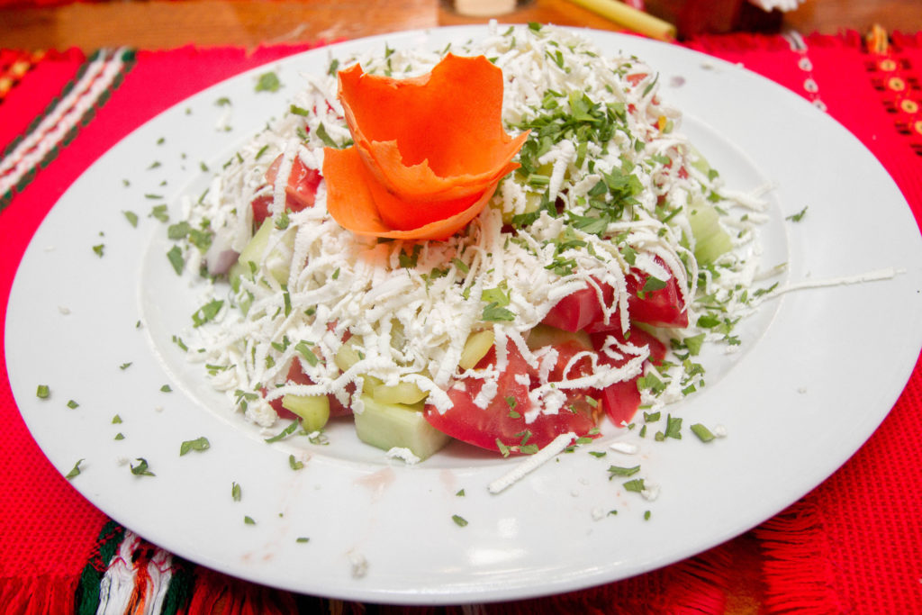 One must-try in Bulagaria is the famous Shopska Salad, sporting the three colors of the Bulgarian flag.