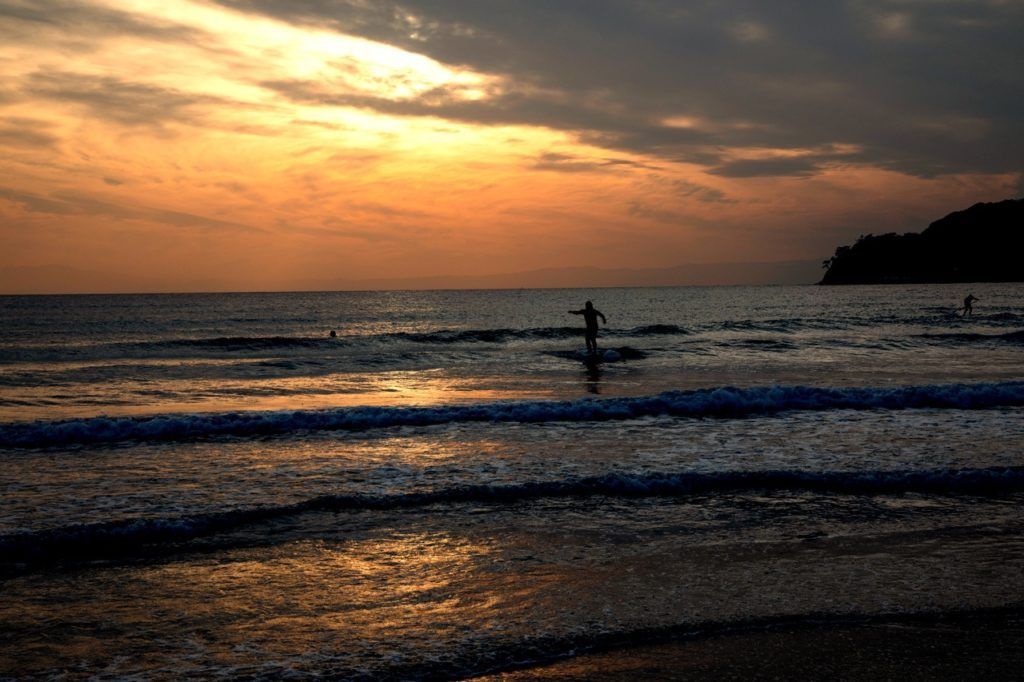 Surfers ride the waves all year long in Kamakura.