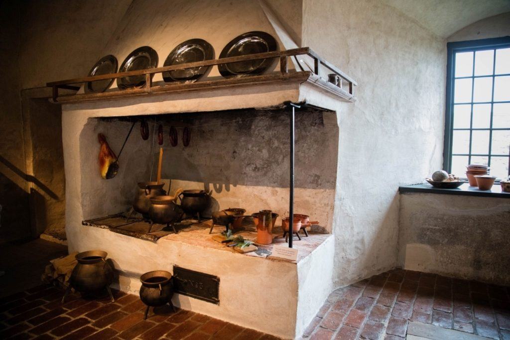 Kalmar castle kitchen with old pots, pans, and stove.