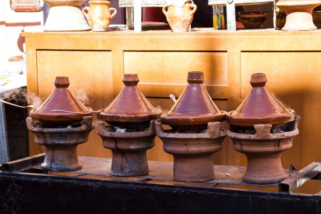 Tajines with Typical Moroccan meals steam along the street in Marrakesh.