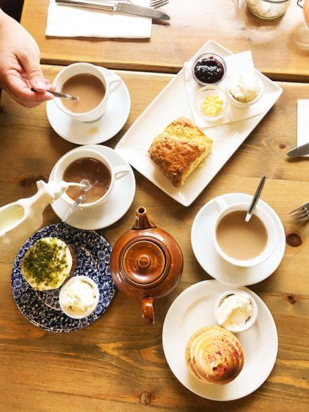 Traditional British Tea with a pot of tea and scones.