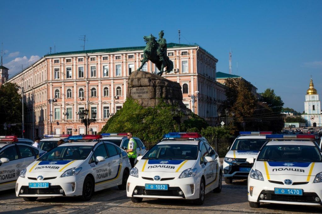 Police Cars in front of a statue in Kiev, Ukraine.