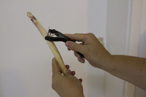 Start by peeling the outer skin of white asparagus.