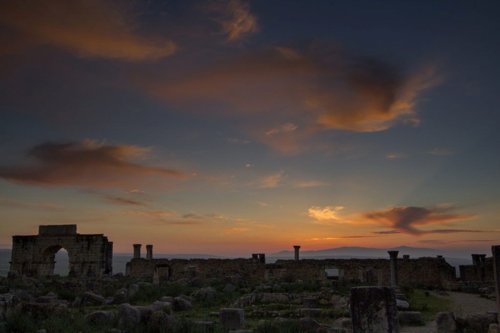 Sun setting on the Roman ruins in Volubilis, Morocco.