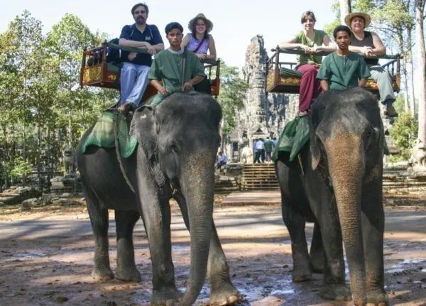 Two elephants take a family for a ride around Bayon temple in Angkor Wat.
