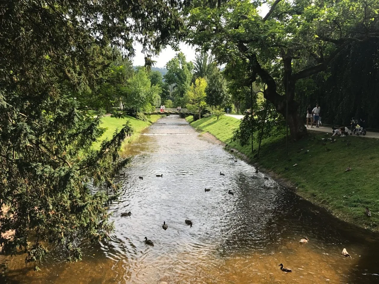 Riverbed and people enjoying a walk during spring in Baden Baden, Germany.