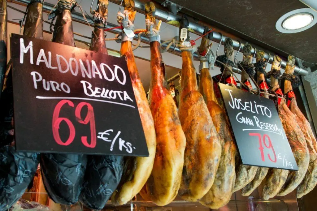 Full legs of Jamon hang in the Boqueria market.
