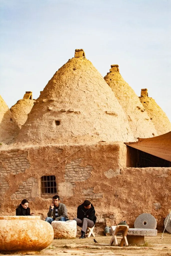 Men sitting in front of museum offering guiding services.