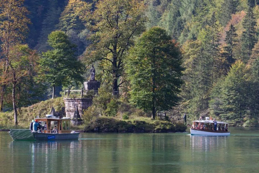 Boats gliding along the water in K&ouml;nigssee Germany.