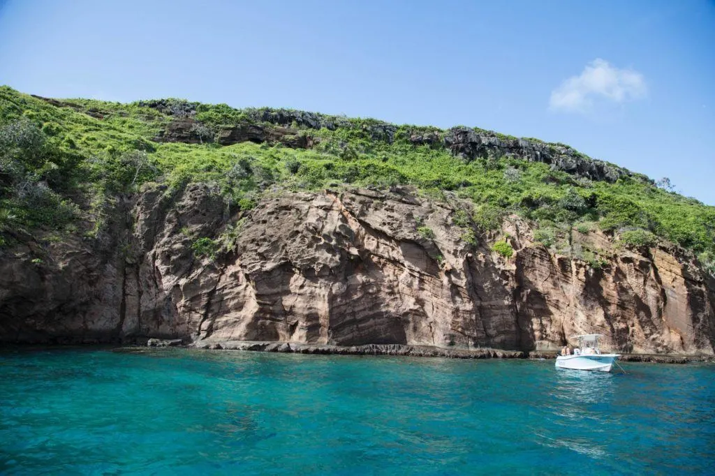 A boat is docked at one of the small islands off of Mauritius.