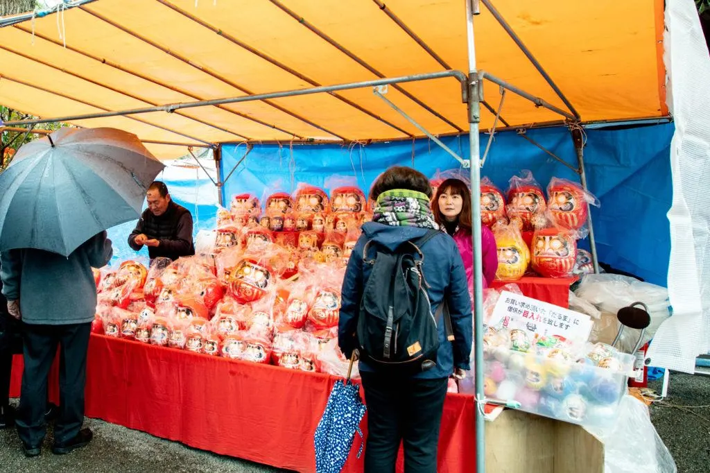 Darumas for sale at a stall in the Daruma festival.