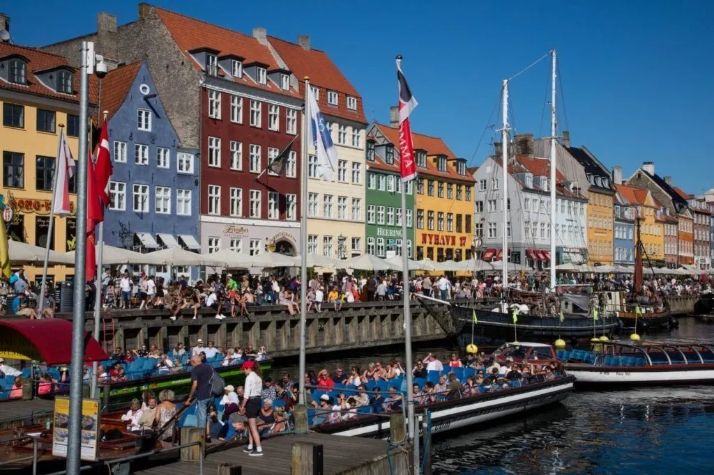 Nyhavn port in Copenhagen bustling with tourists.