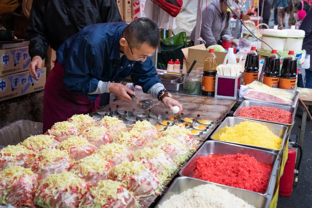 Okonomiyaki on the grill at the Daruma Festival.