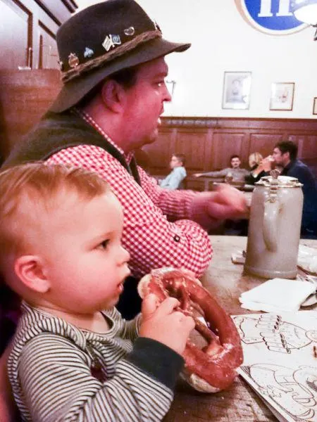 Little boy eating a pretzel.