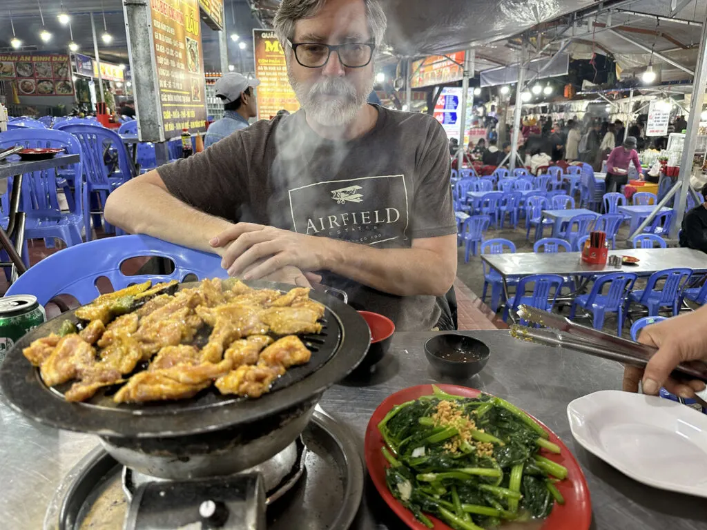 Dalat Night Market dinner, grilled pork and the ubiquitour morning glory.