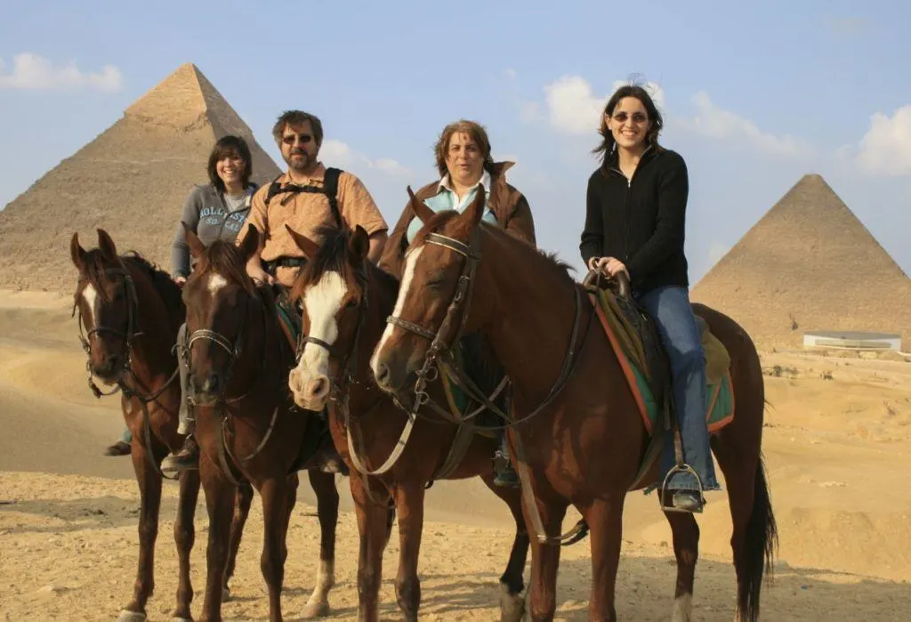 Family Riding Horses at the pyramids in Giza.