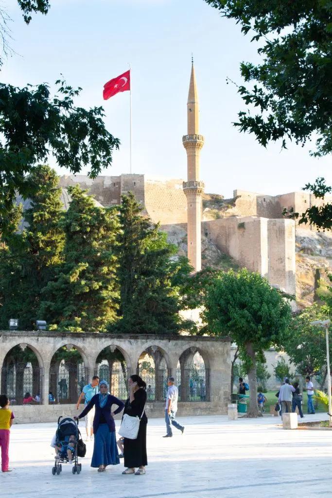 Tourists in the park under Urfa Kalesi.