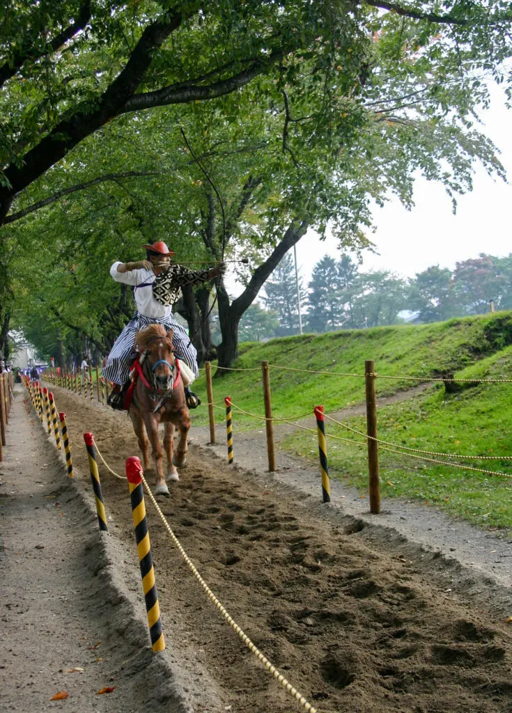 Koma archer shoots from his horse.