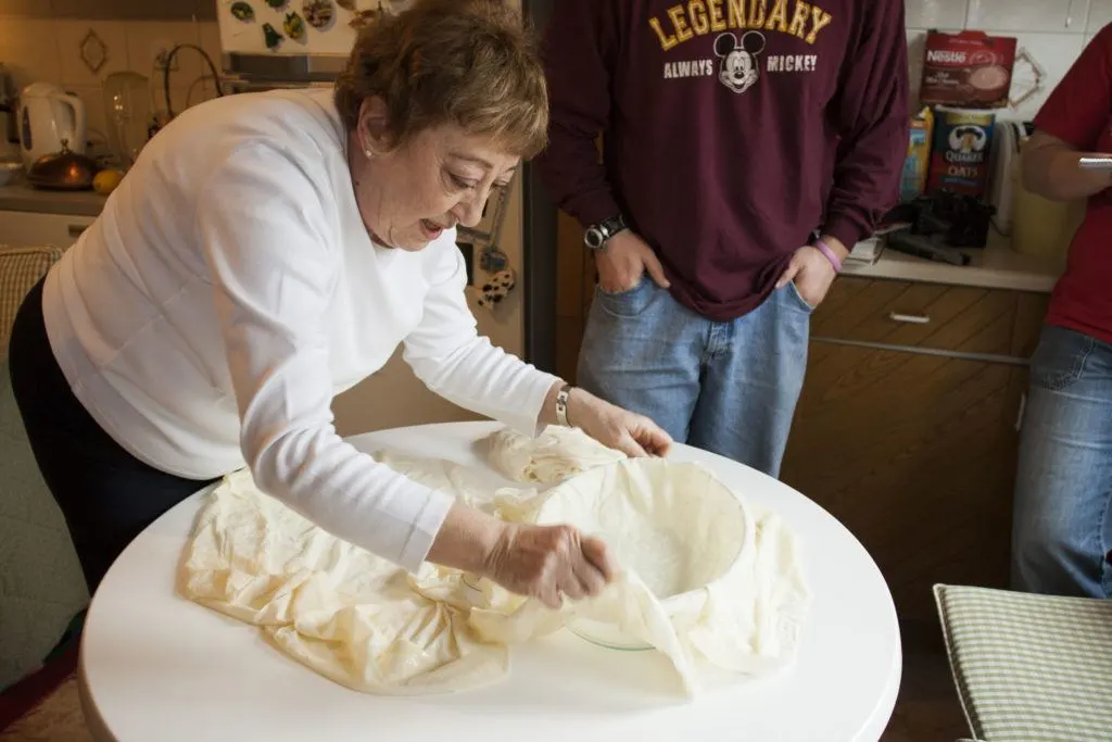 Fusun is laying the first sheet of yufka for the layered borek.
